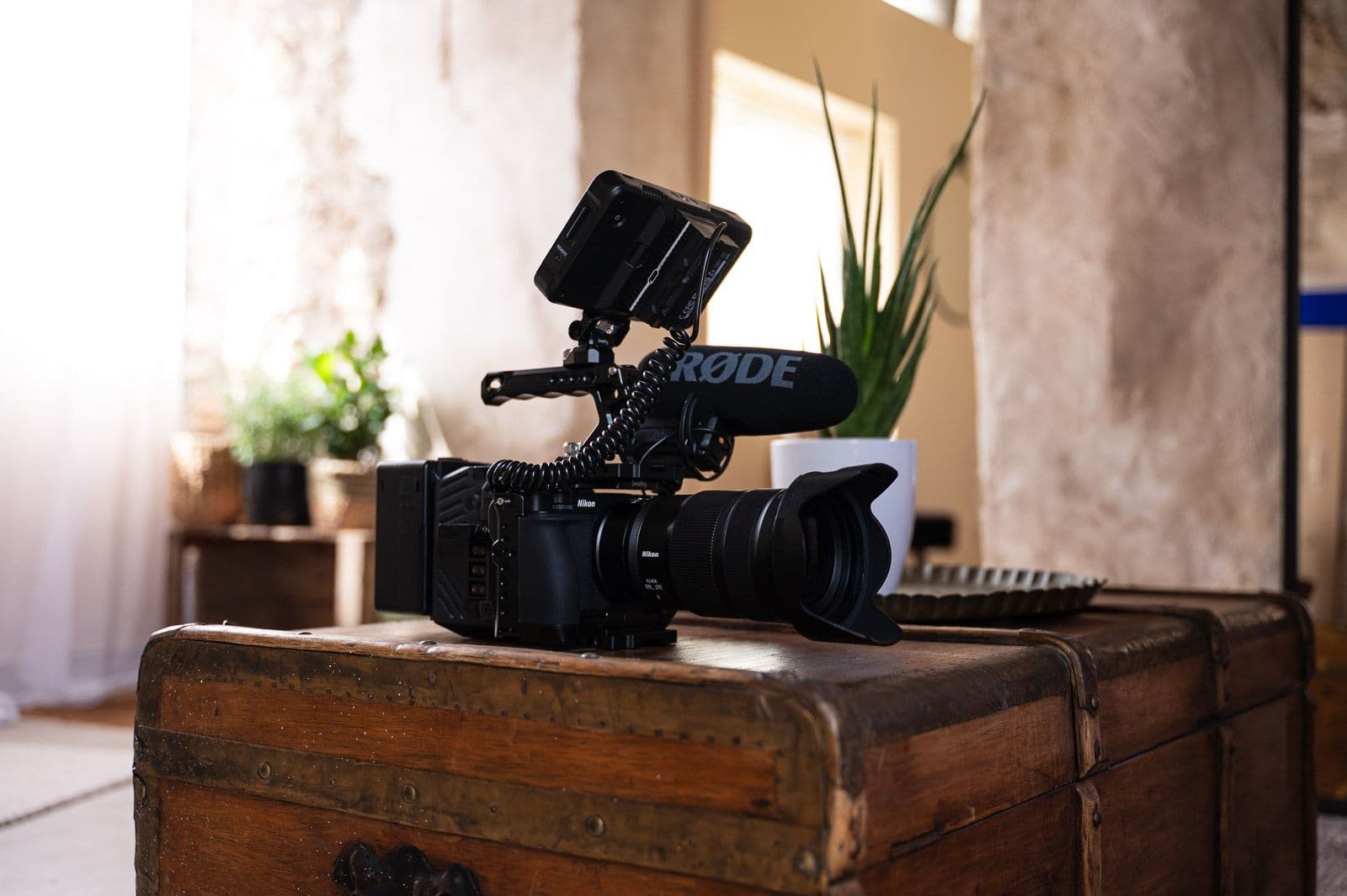 Agence Dubois camera and microphone resting on a trunk in a bright interior